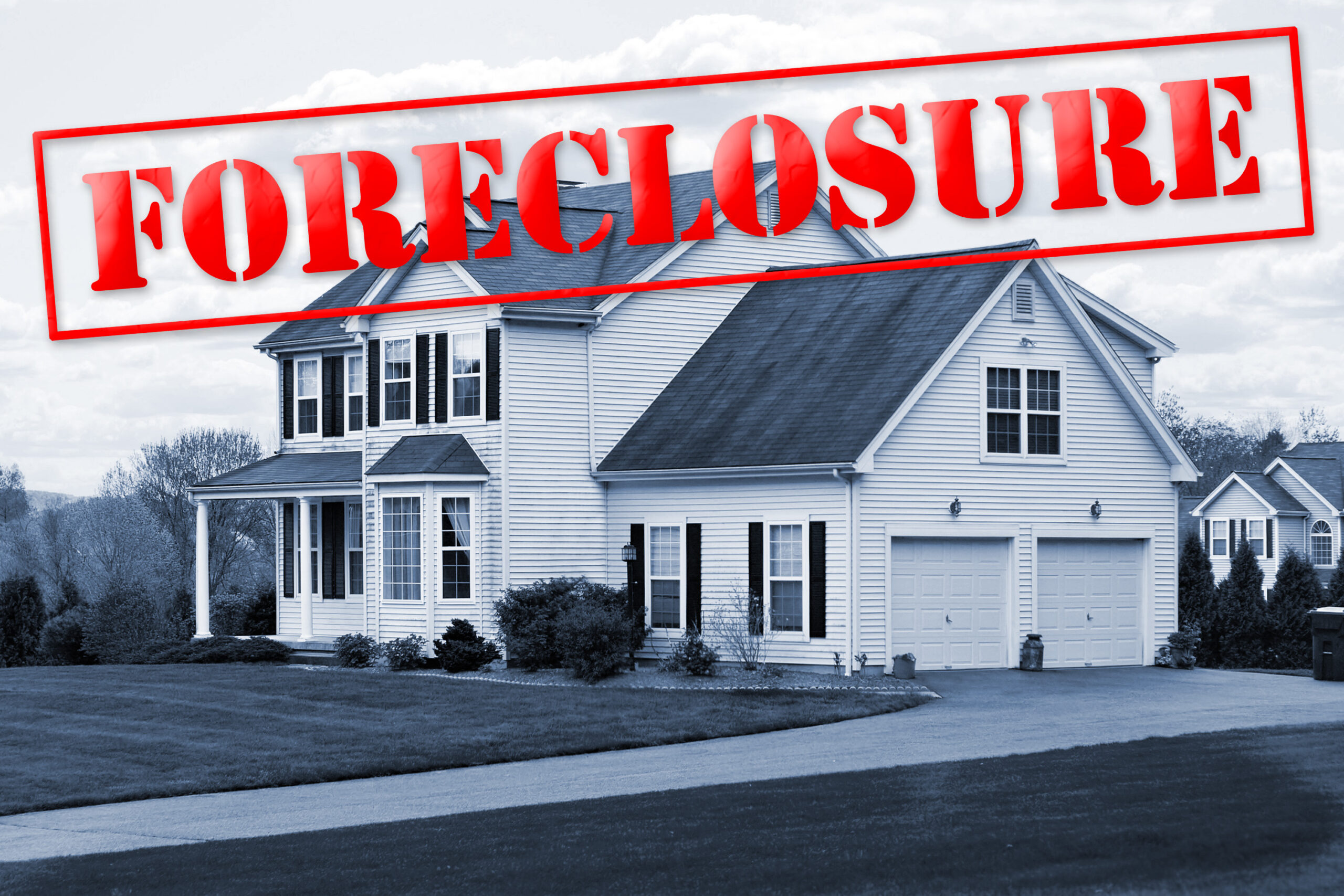 A foreclosed house with a red foreclosure stamp running along the top of the picture.